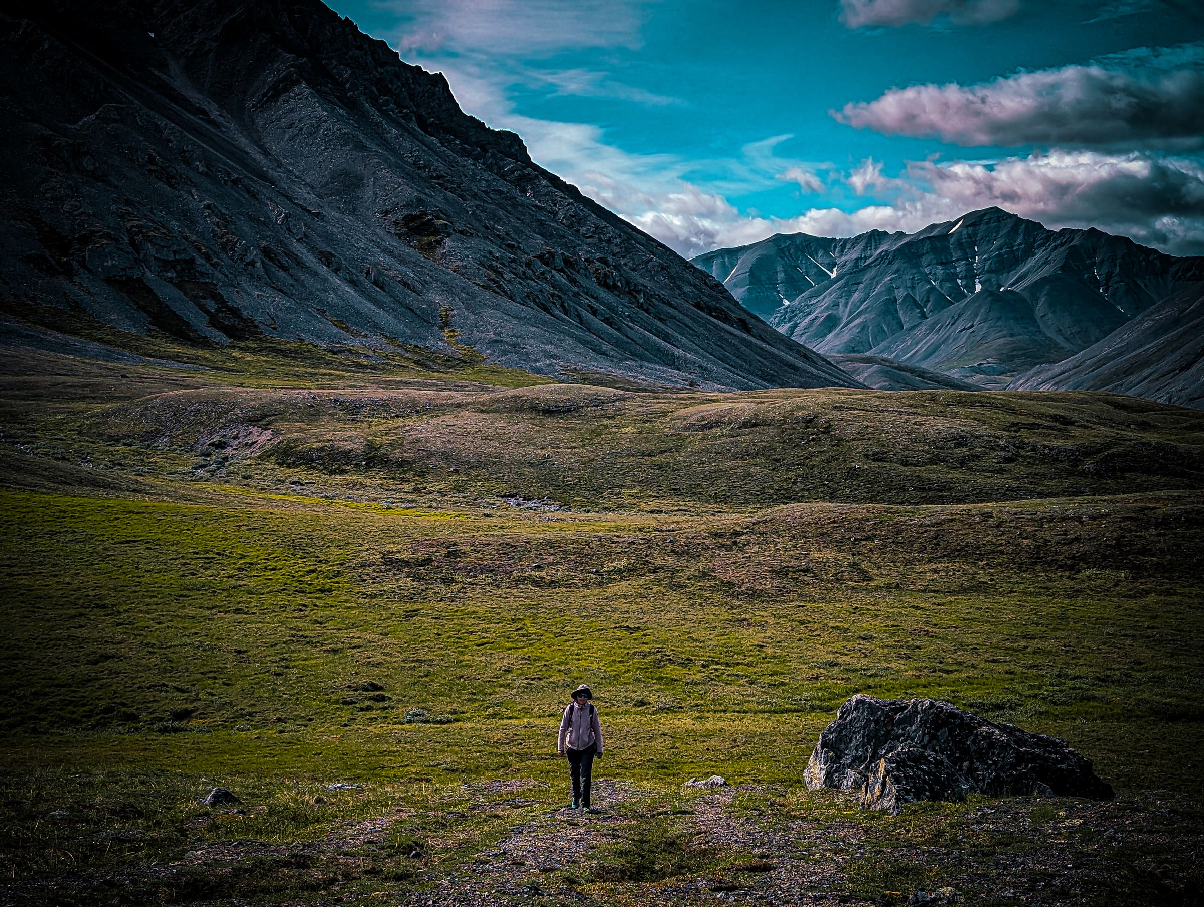 Hiker in vast Alaska mountain valley